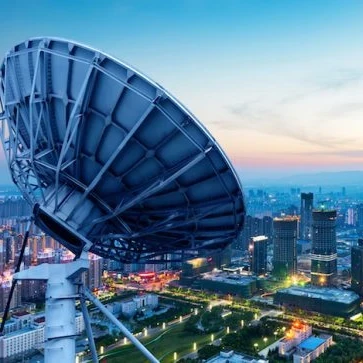 satellite over a city at dusk
