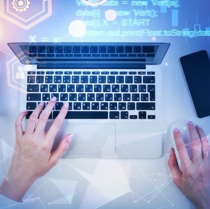 Person sitting at a desk and typing on a keyboard.
