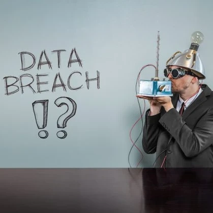 Conspiracy theorist standing in front of a board that reads 'data breach?!'