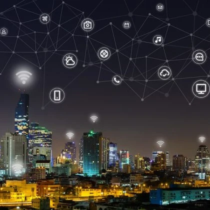 Technology icons overlaid on a city skyline at night.