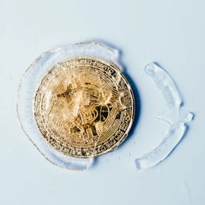 bitcoin coin in gold frozen in ice