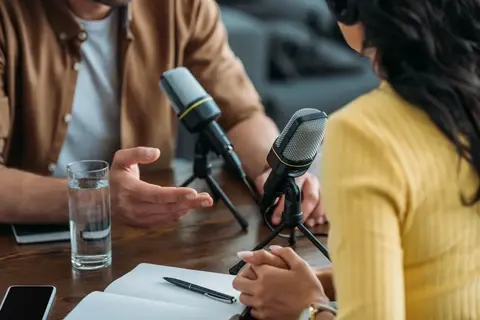 Two people recording a podcast