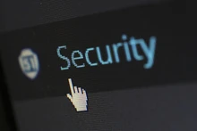 cybersecurity on a screen with mouse icon hovering over 